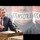 Keir Starmer in front of people with the word 'CENSORED' taped over their mouths