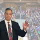Nigel Farage in front of an image of parliament
