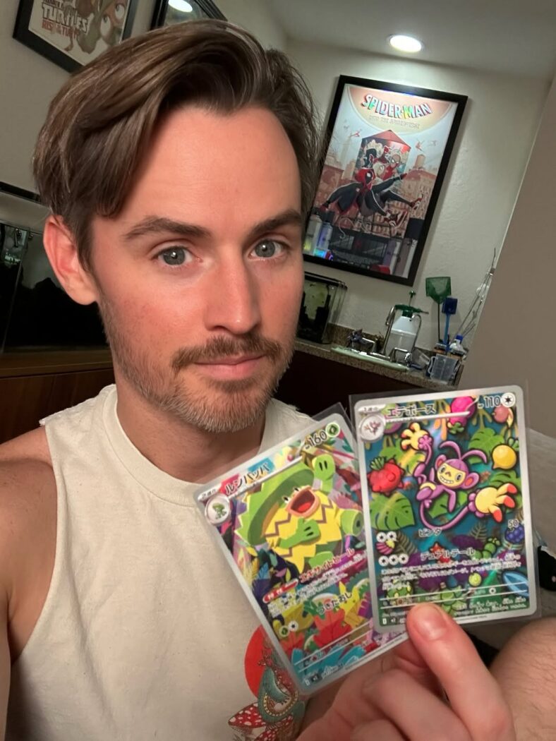 Daniel Benson holding up cards