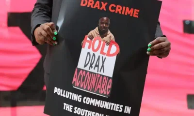 Dr Krystal Martin Holds Placard in Front of Drax AGM