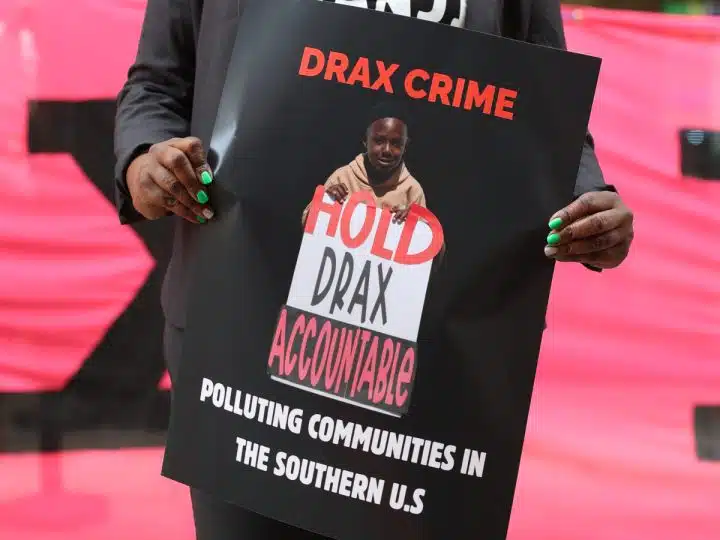 Dr Krystal Martin Holds Placard in Front of Drax AGM