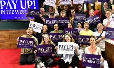 Equity members hold placards supporting the union's Pay Up! campaign in London's West End