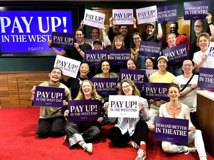 Equity members hold placards supporting the union's Pay Up! campaign in London's West End