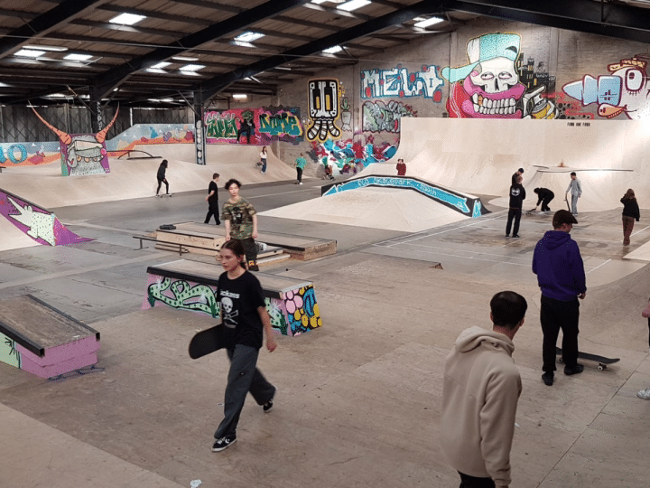 A mock-up photograph of what the Flo Skatepark would look like once opened with graffitti on the walls and young people walking over ramps with their skateboards