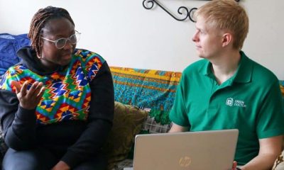Green Doctors project manager, Daniel Brittle, holding a laptop, speaking to service user Pearl.