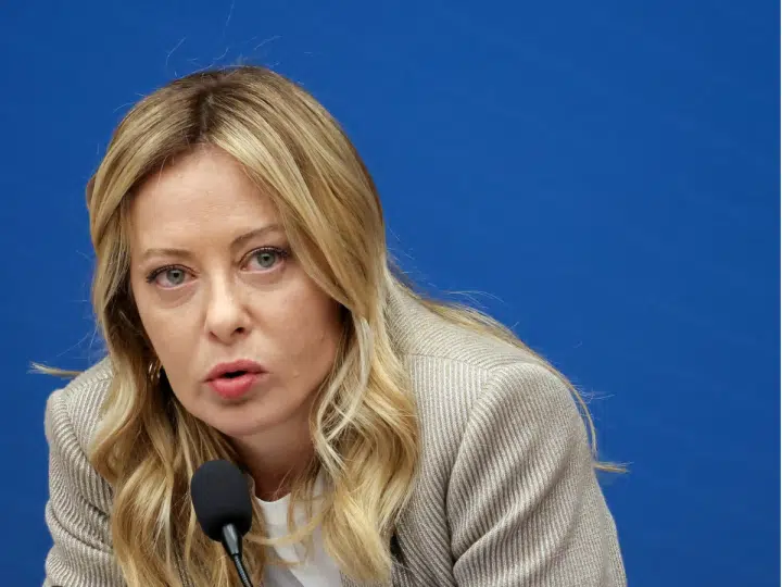 Italy Prime Minister Giorgia Meloni speaking into a microphone