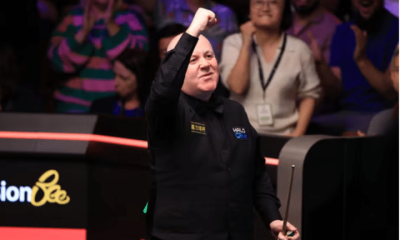 John Higgins celebrates victory over Ronnie O'Sullivan