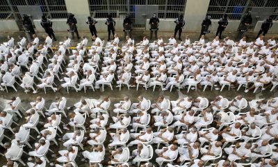In El Salvador, shackled prisoners watch their mass trial on a big screen