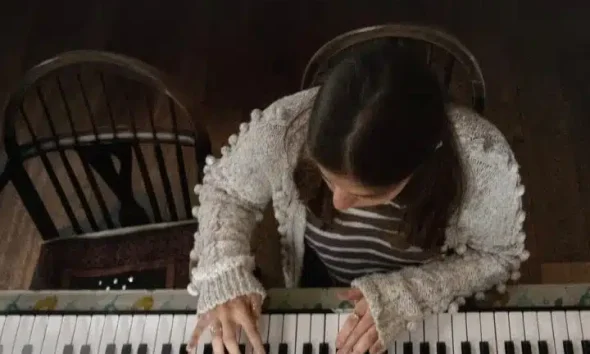 A girl plays a piano in a publicity still from 'Little Rock', from the Dementia Doesn’t Care campaign
