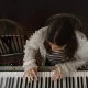 A girl plays a piano in a publicity still from 'Little Rock', from the Dementia Doesn’t Care campaign