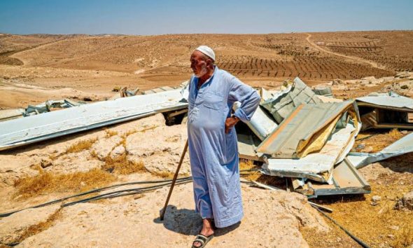 A resident of the Masafer Yatta community looks over his demolished home in 2022