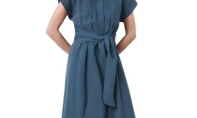 A woman wearing a medium-blue shirtdress