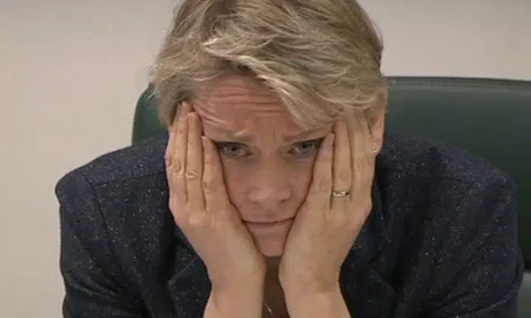 Yvette Cooper with her face in her hands, looking worried