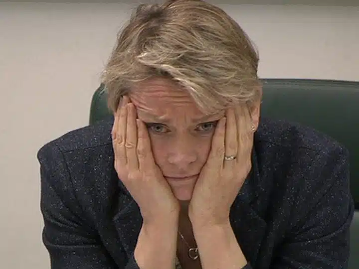 Yvette Cooper with her face in her hands, looking worried