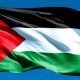 Close image of Palestine flag against blue sky. Pledge for Palestine