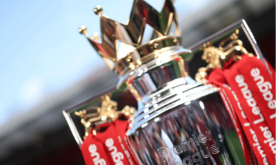 A close-up of the regal looking Premier League trophy that has 'Premier League' engraved into the silver at the front and tassels hanging from the sides