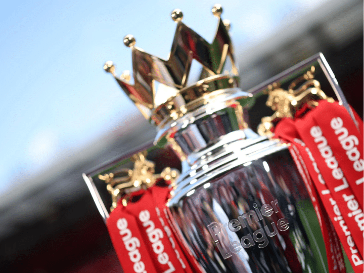 A close-up of the regal looking Premier League trophy that has 'Premier League' engraved into the silver at the front and tassels hanging from the sides