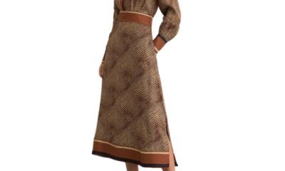 A woman wearing an animal-print dress and brown high-heeled sandals