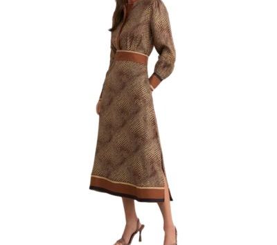 A woman wearing an animal-print dress and brown high-heeled sandals