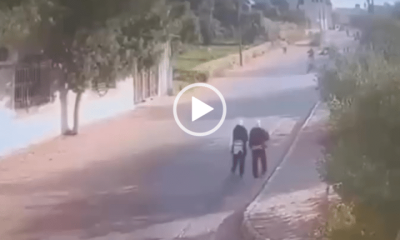 A moment of calm before the car hits the schoolgirls as they walk alongside the empty street during the daytime in Palestine