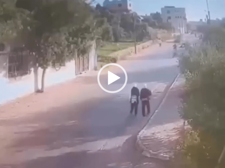 A moment of calm before the car hits the schoolgirls as they walk alongside the empty street during the daytime in Palestine