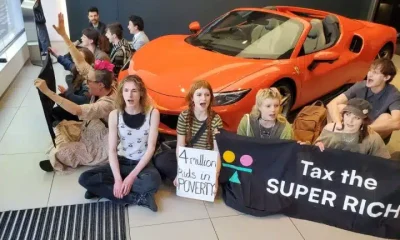Take Back Power supporters stage a sit-in in a Ferrari dealership