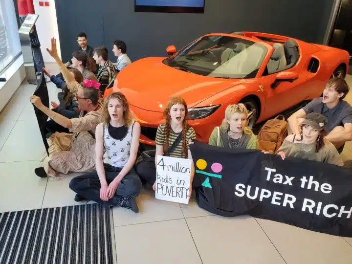 Take Back Power supporters stage a sit-in in a Ferrari dealership
