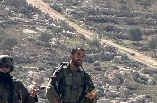 Israeli occupation soldiers photographed against a backdrop of rocky hills in April 2026