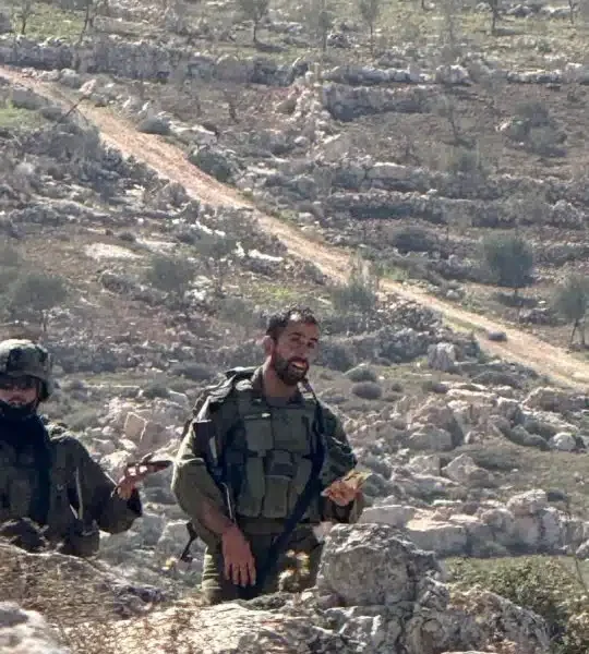 Israeli occupation soldiers photographed against a backdrop of rocky hills in April 2026