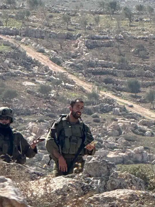 Israeli occupation soldiers photographed against a backdrop of rocky hills in April 2026