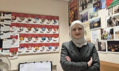 Sundos Hammad stands with her hands folded and smiling