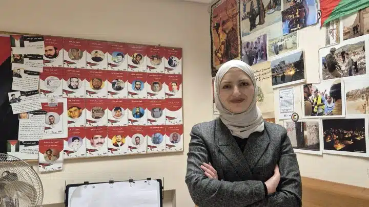 Sundos Hammad stands with her hands folded and smiling