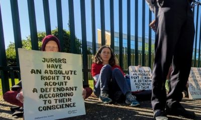 Protesters hold placards outside Woolwich Crown Court