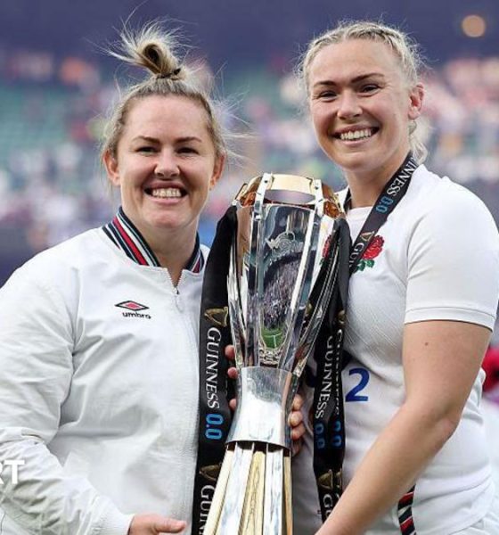 Marlie Packer and Rosie Galligan pose for a photograph holding the RWC trophy