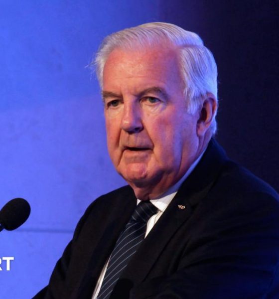 Sir Craig Reedie speaking at a podium in 2018