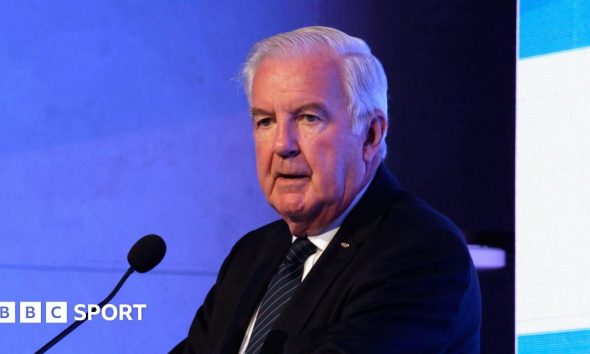 Sir Craig Reedie speaking at a podium in 2018