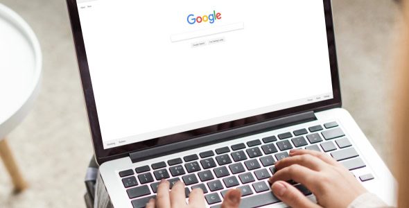 stylish professional woman is ready to Google something on her laptop