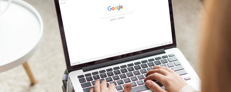 stylish professional woman is ready to Google something on her laptop