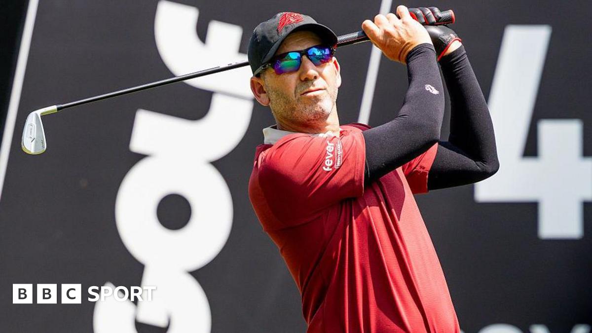 Sergio Garica tees off during a LIV Golf tournament with the branding in the background