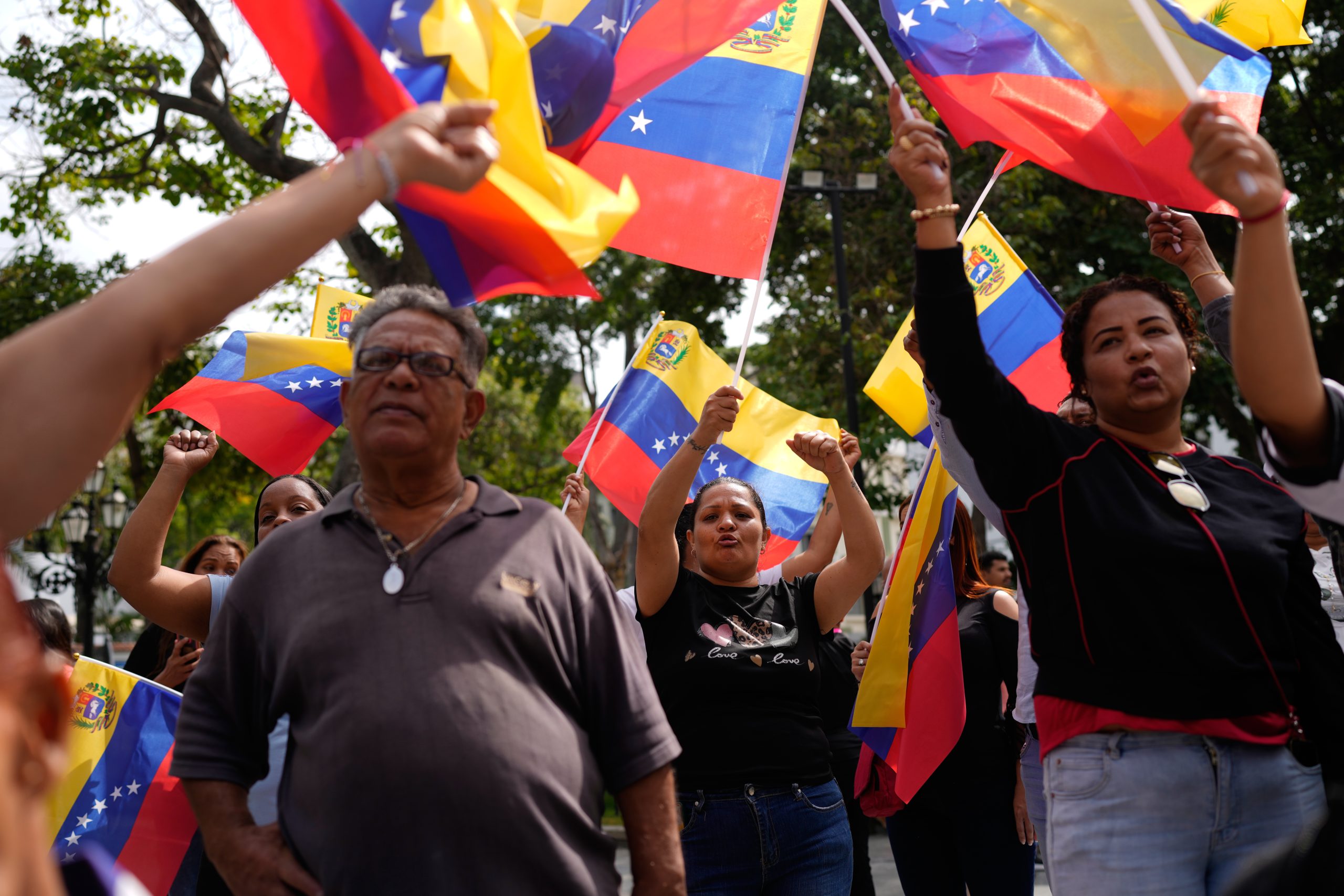People gather at a government-organized event to watch former President Nicolas Maduro and first lady Cilia Flores appear in a New York court on a screen in Caracas, Venezuela, on March 26, 2026.