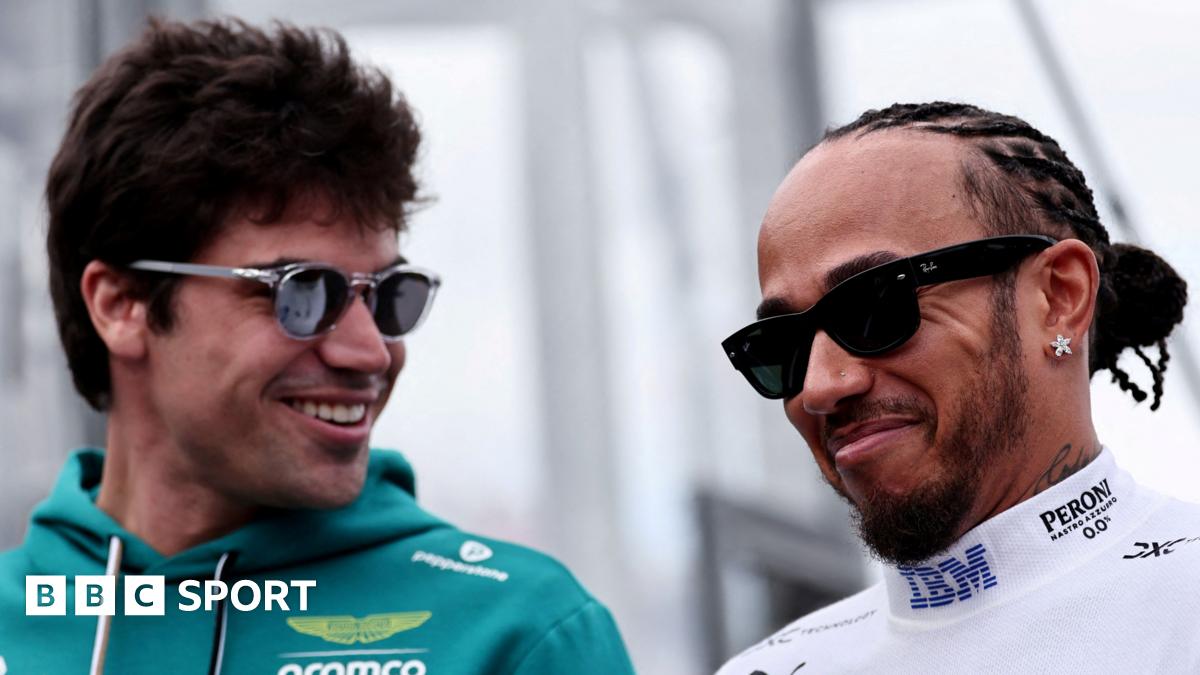 Aston Martin driver Lance Stroll and Ferrari driver Lewis Hamilton smiling while in conversation at the 2026 Australian Grand Prix. Both men are wearing sunglasses