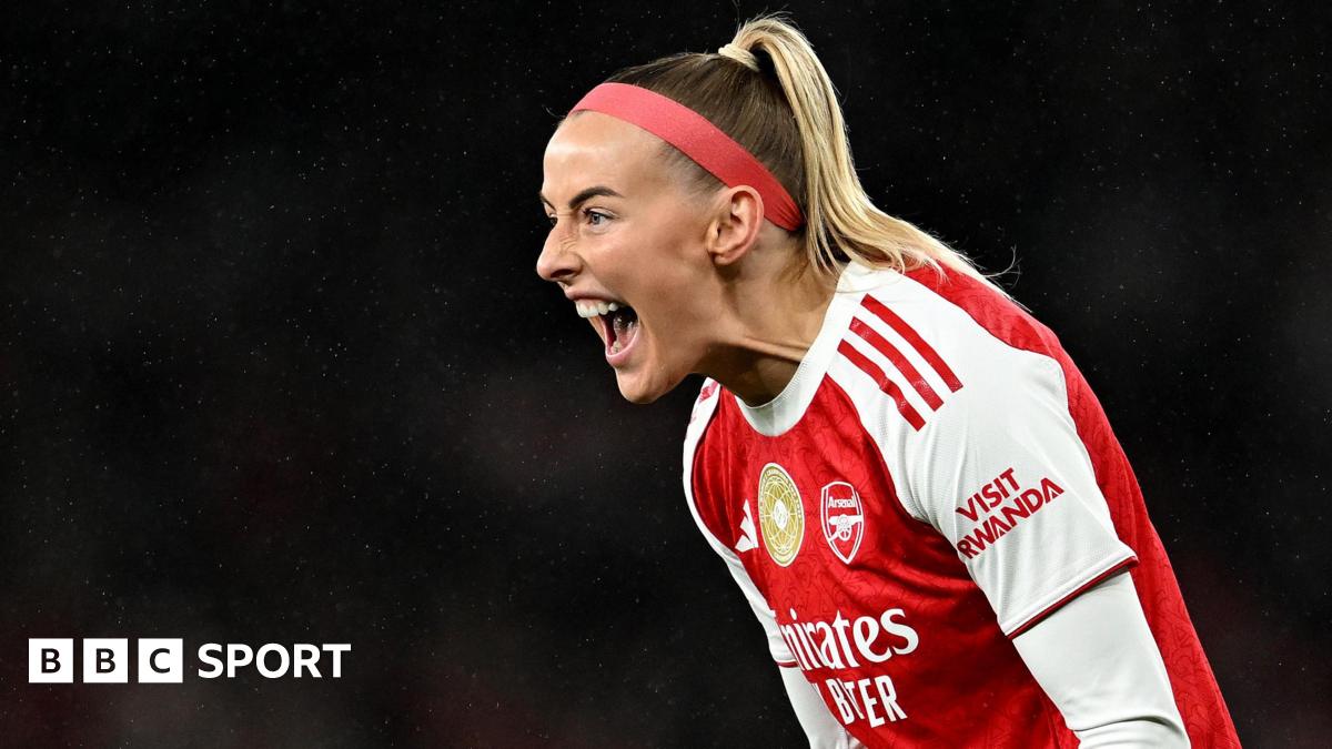 Chloe Kelly slides on her knees in celebration while wearing Arsenal's red and white kit and a red headband