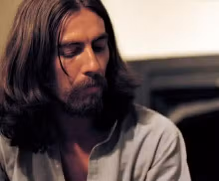bearded-george-harrison-turning-to-his-right-in-george-harrison-living-in-the-material-world