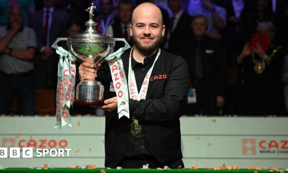 Luca Brecel holding the World Snooker Championship trophy