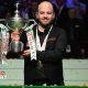 Luca Brecel holding the World Snooker Championship trophy