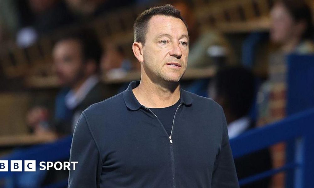 Former Chelsea player John Terry walks along the touchline at Stamford Bridge ahead of a Premier League 2 youth match in 2025