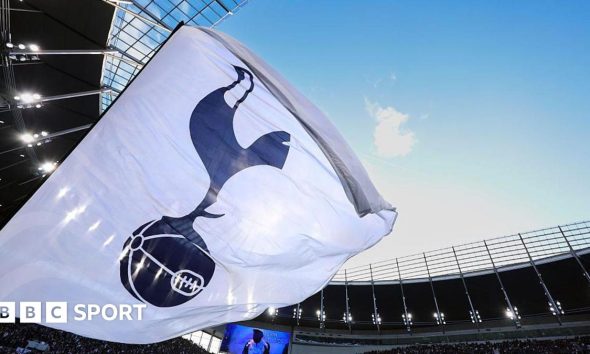 A white flag with a Tottenham Hotspur crest on it