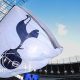 A white flag with a Tottenham Hotspur crest on it