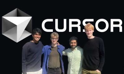 Four people smiling in front of the Cursor AI logo on a black background.