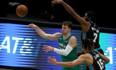 Dallas Mavericks star Luka Doncic passes the ball against Brandon Clarke, 15, and Justise Winslow ,7, of the Memphis Grizzlies in the second half at American Airlines Center